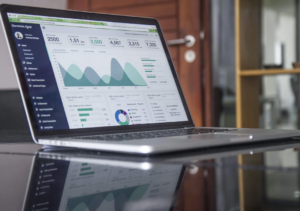 laptop with graphs on the screen