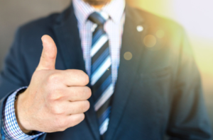 man in suit giving thumbs up